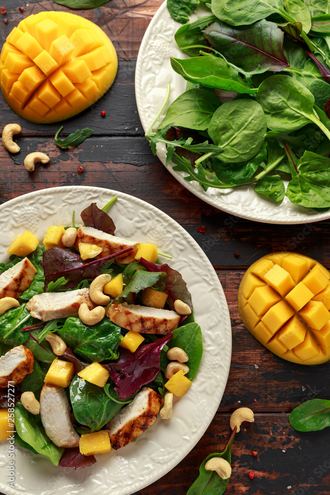 Grilled Chicken Mango salad with nuts and vegetables. Healthy food.