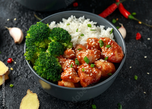 Photography Teriyaki chicken, steamed broccoli and basmati rice served in two Asian clay bow