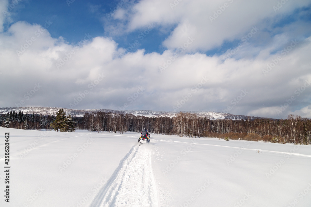 Athlete on a snowmobile.