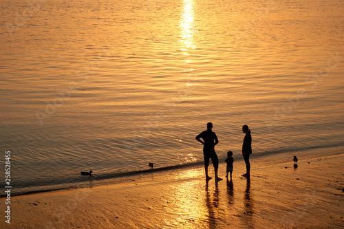 family at sunset at a beach