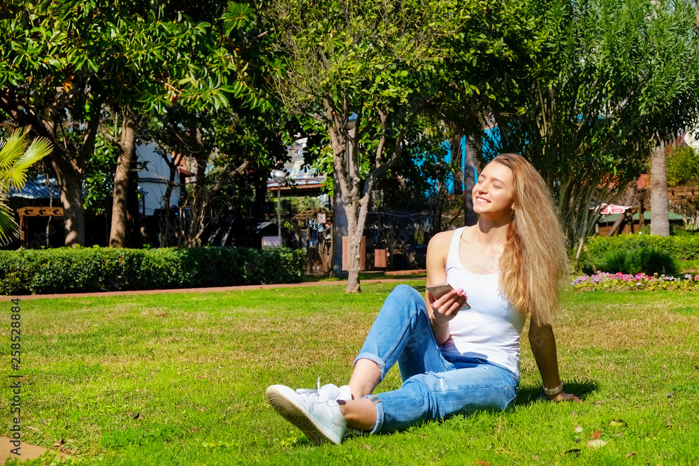 Portrait of young beautiful woman in tropical destination park with greenery on the background. Joy of summer holidays concept. Close up, copy space. Portrait of young beautiful woman in tropical destination park with greenery on the background. Joy of summer holidays concept. Close up, copy space.