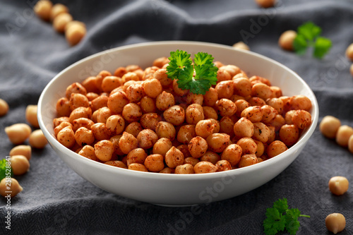Roasted spicy chickpeas in white bowl. Healthy food