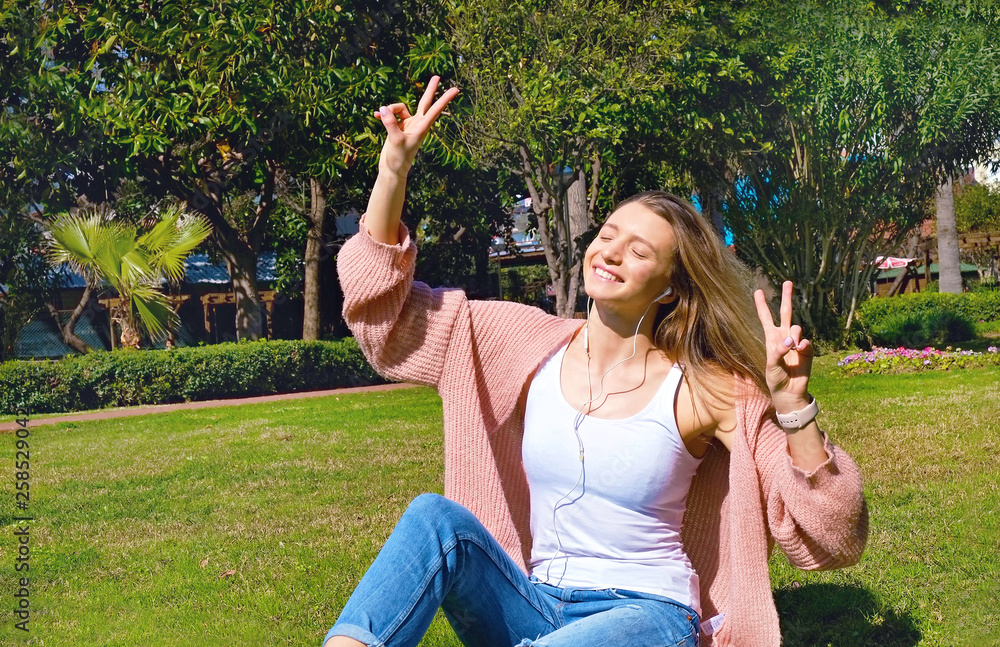 Portrait of young beautiful woman in tropical destination park with greenery on the background. Joy of summer holidays concept. Close up, copy space. Portrait of young beautiful woman in tropical destination park with greenery on the background. Joy of summer holidays concept. Close up, copy space.