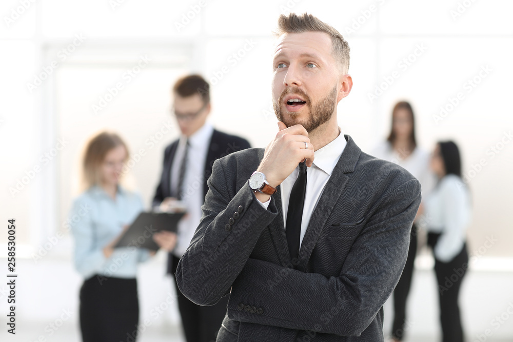 portrait of a dreaming businessman on a blurred office background portrait of a dreaming businessman on a blurred office background