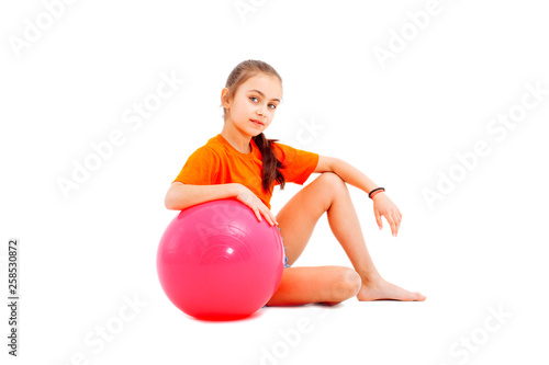 Fitness girl holding pilates ball.