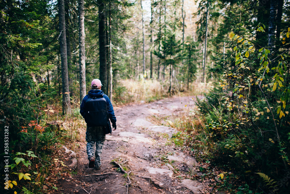 Man hiking at sunset mountains with heavy backpack Travel Lifestyle wanderlust adventure concept summer vacations outdoor alone into the wild Man hiking at sunset mountains with heavy backpack Travel Lifestyle wanderlust adventure concept summer vacations outdoor alone into the wild