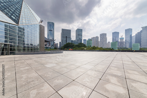 Panoramic skyline and modern business office buildings with empty road empty concrete square floor