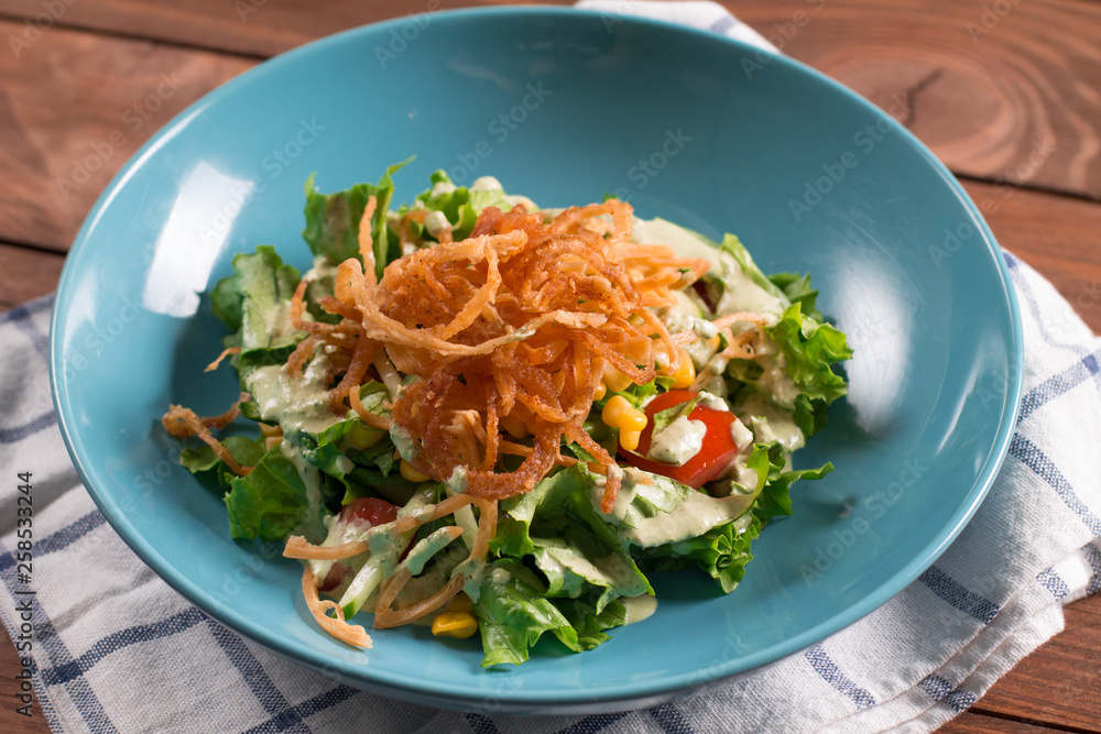 Mexican salad with tomatoes, mixed greens, fried onions Mexican salad with tomatoes, mixed greens, fried onions