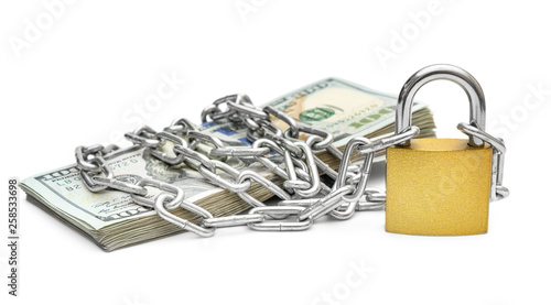Quadro em tela Stack of money wrapped by metal chain with padlock on white background