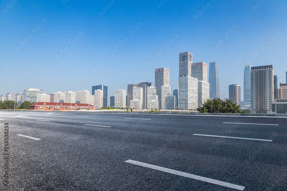 Panoramic skyline and modern business office buildings with empty road,empty concrete square floor Panoramic skyline and modern business office buildings with empty road,empty concrete square floor