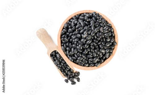 black bean in wooden bowl and scoop isolated on white background. nutrition. food ingredient.