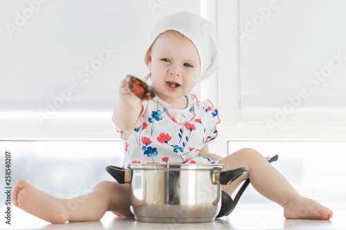 Картината върху платно The kid with the pan on a white background.