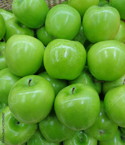 Vertical Image of Pile of Vibrant Color Fresh Green Apples 