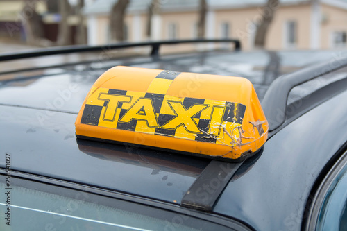 old and worn lantern with a taxi sign 