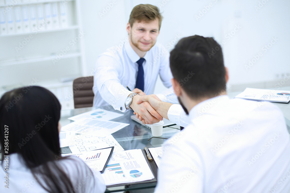 handshake of financial partners at a business meeting in the office handshake of financial partners at a business meeting in the office