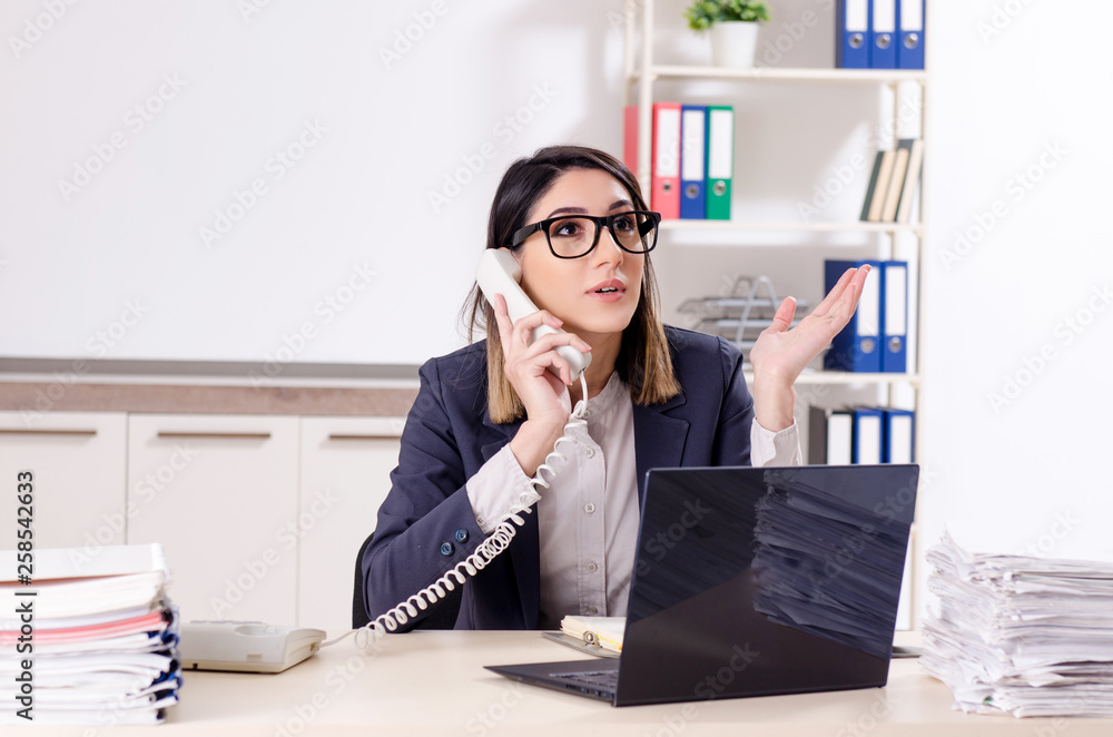 Young female employee working in the office Young female employee working in the office