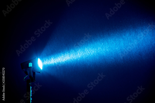 spotlight through the snow in the night sky