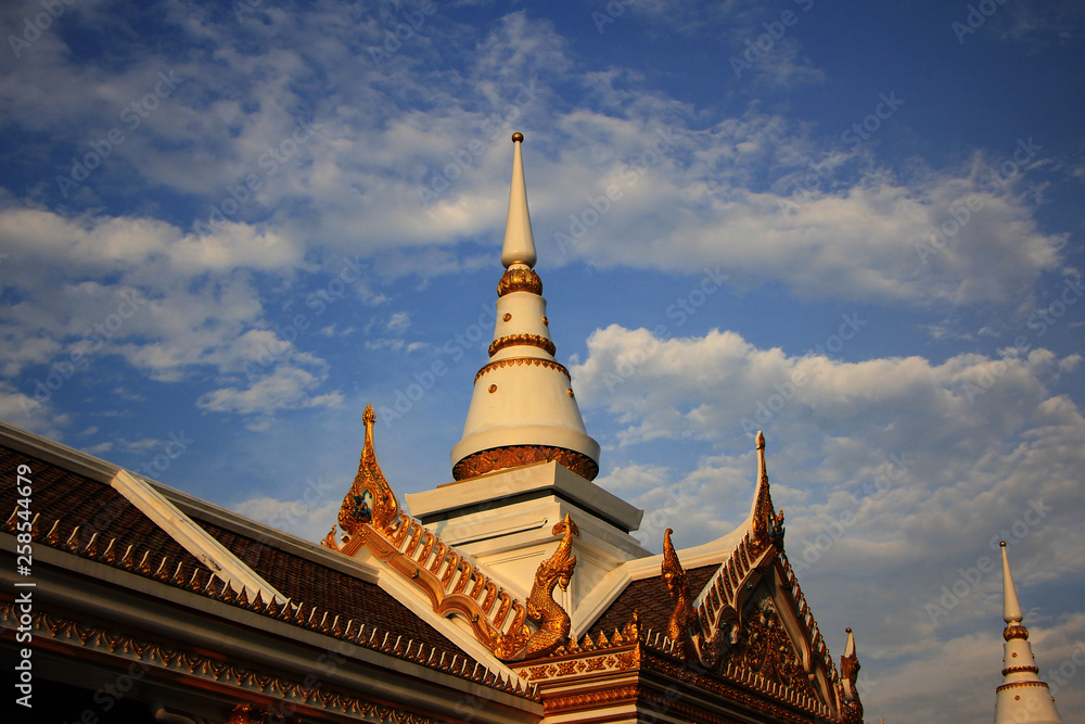 Fototapeta premium temple in thailand with pagoda under blue sky.