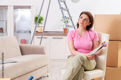 Woman choosing color for flat renewal 