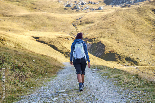 Woman hiking on a trail in the valley 