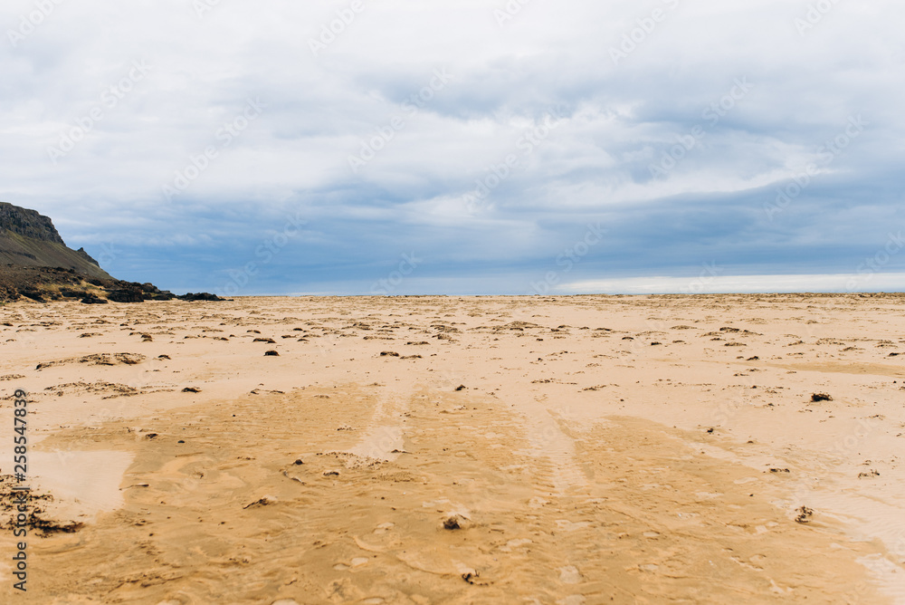 Ocean beach with yellow sand. Embankment of the ocean and Iceland. Ocean beach with yellow sand. Embankment of the ocean and Iceland.