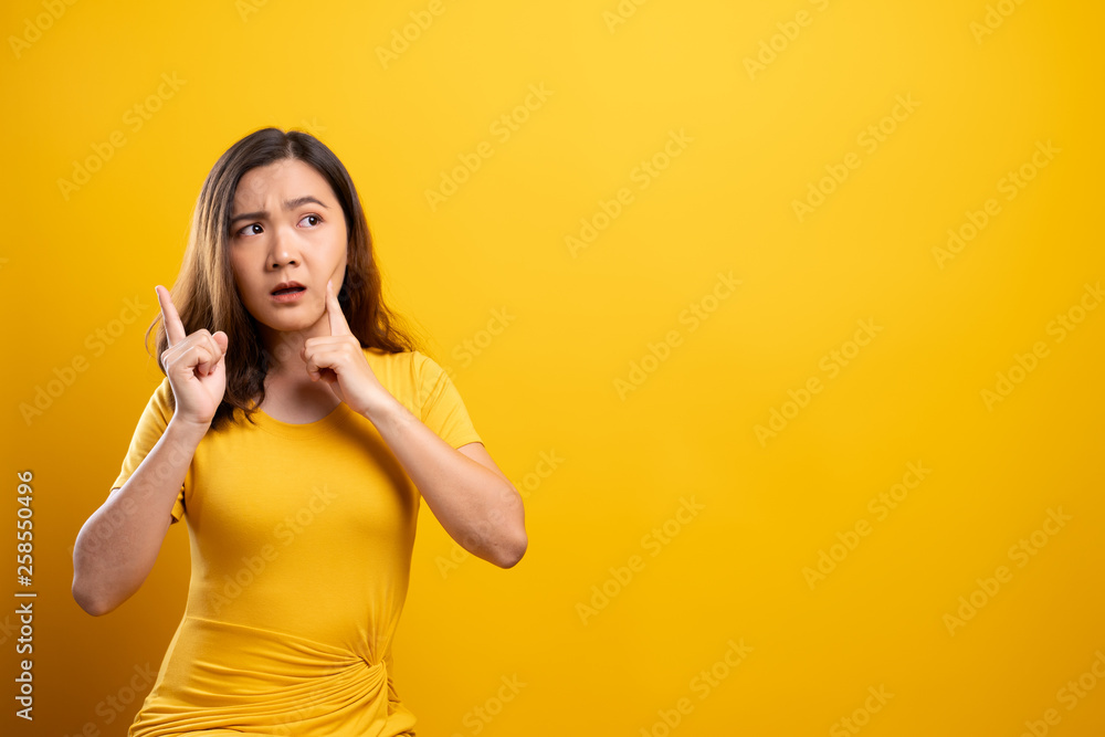 Woman feel confused isolated over yellow background Woman feel confused isolated over yellow background