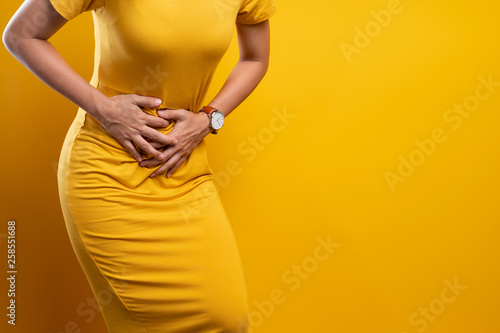 Woman suffers from stomach ache Close up photo