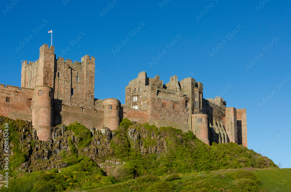 Bamburgh Castle and rocks and blue sky