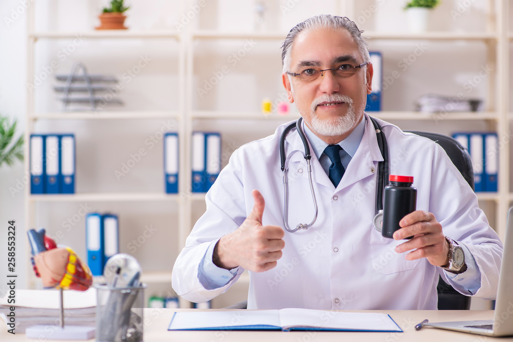 Aged male doctor working in the clinic Aged male doctor working in the clinic