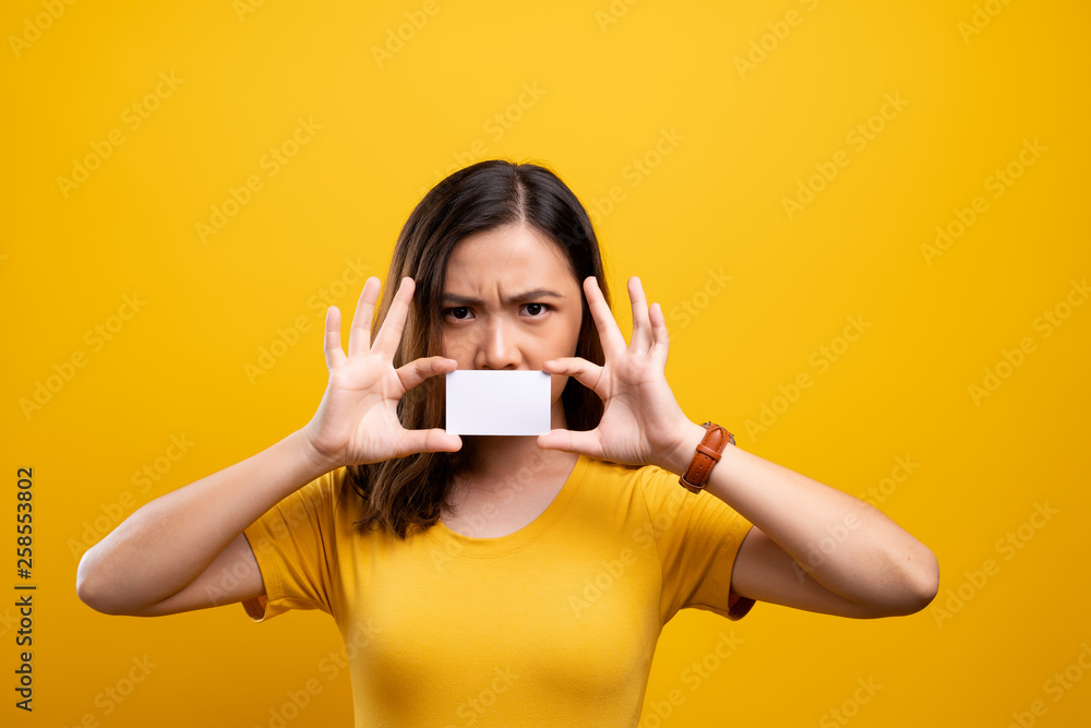 Angry woman covering face with paper card Angry woman covering face with paper card