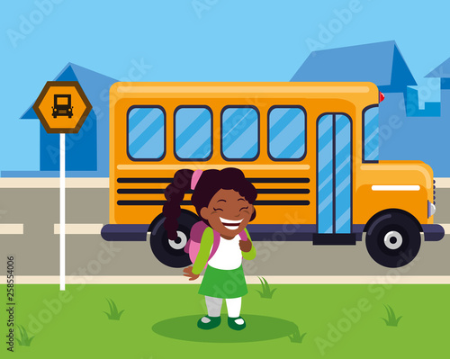 little black schoolgirl with schoolbag in the stop bus