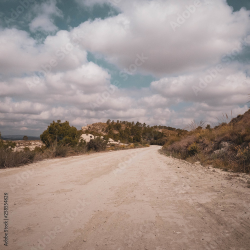 Dirt path / road on the mountain in a sunny dry day