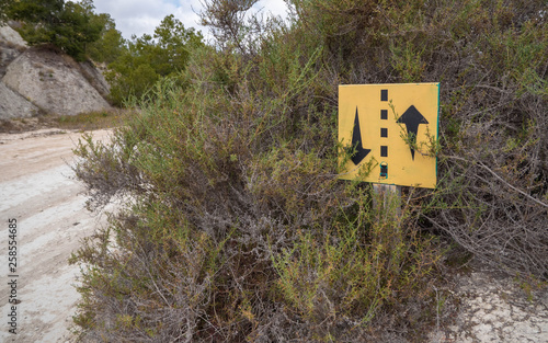 Yellow sign on a mountain dirt road