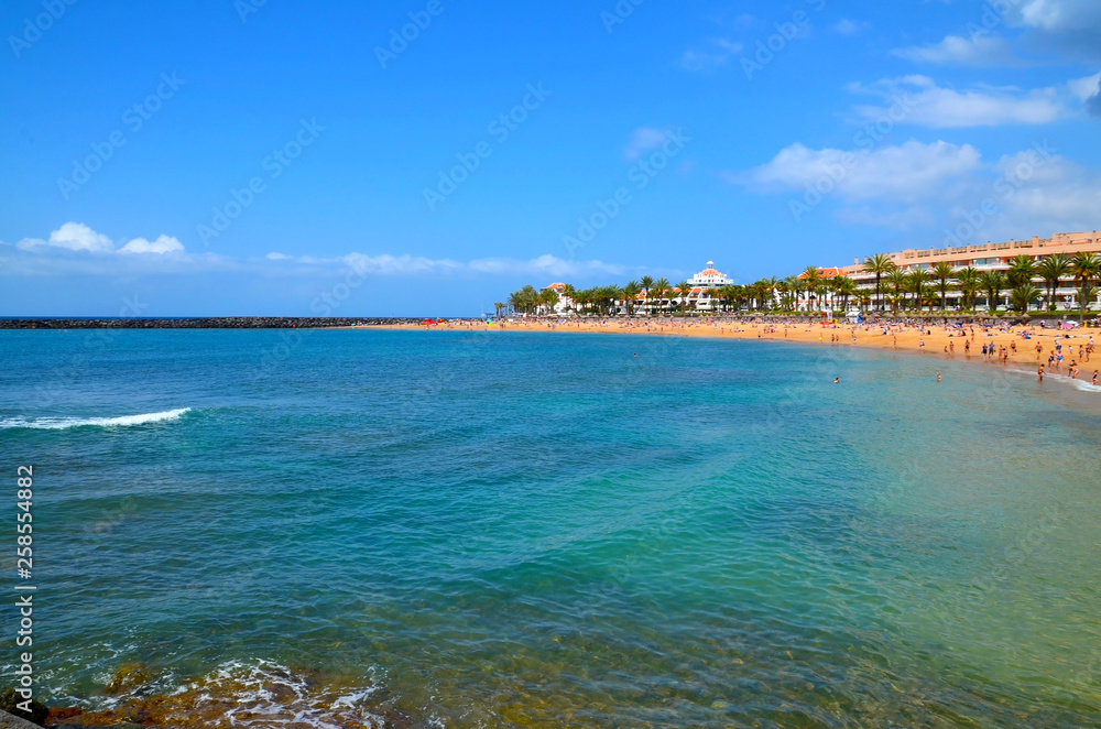 Beautiful coastal view of Playa del Camison beach with turquoise water and yellow sand in Las Americas, Tenerife,Canary Islands,Spain.Travel or vacation concept.