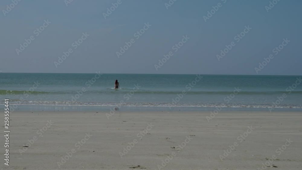 A girl in a bathing suit happily enters the sea. 4K A girl in a bathing suit happily enters the sea. 4K
