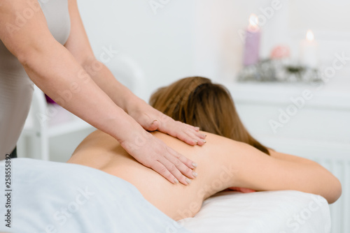 Massage natural session  woman receiving back massage from professional masseur