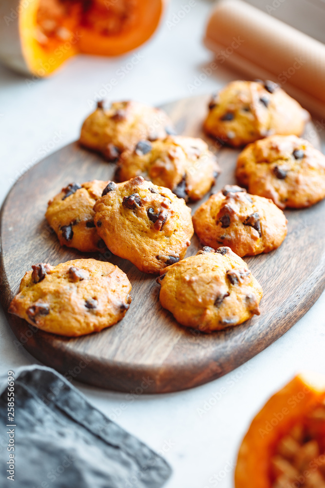 Pumpkin cookies with chocolate chips made from cake mix on a wooden tray.