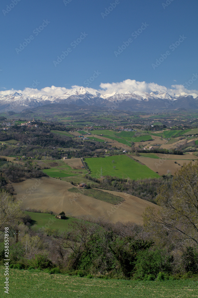 landscape in Italy,Monti Sibillini,spring,tourism,panoramic,view,countryside,hill,rural,field,green,outdoor,clouds,sky,travel
