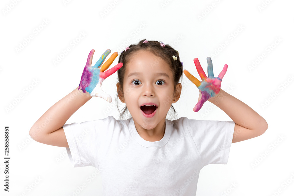 cute surprised little child girl with hands painted in colorful paint isolated on white background. cute surprised little child girl with hands painted in colorful paint isolated on white background.