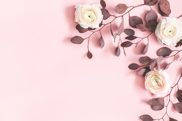 Flowers composition. Pink flowers and eucalyptus leaves on pastel pink background. Flat lay, top view, copy space