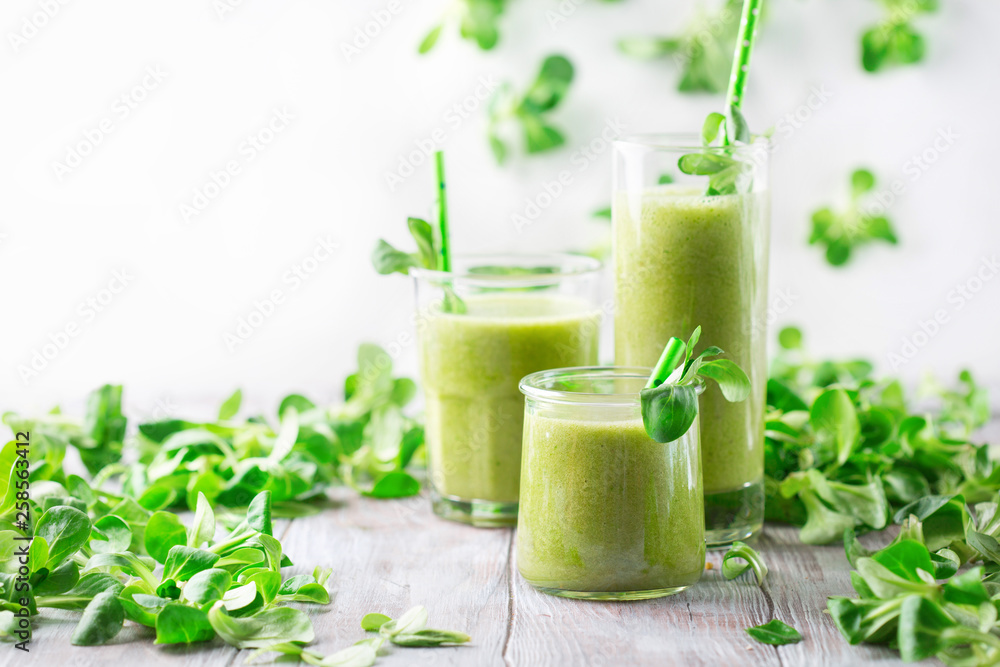 Detox diet concept: Green spinach smoothie on table Detox diet concept: Green spinach smoothie on table