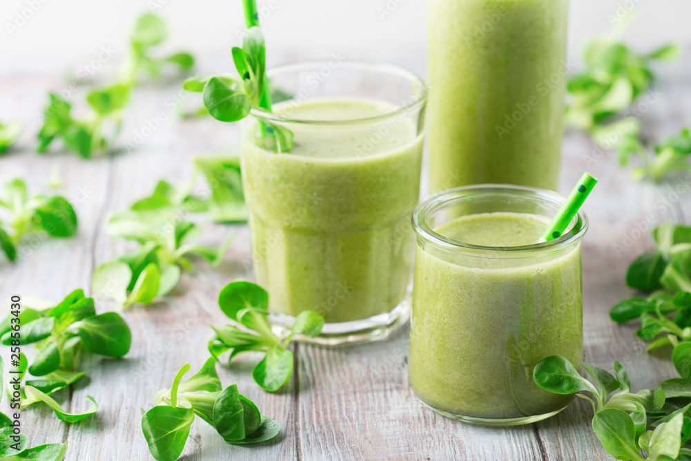 Detox diet concept: Green spinach smoothie on table Detox diet concept: Green spinach smoothie on table