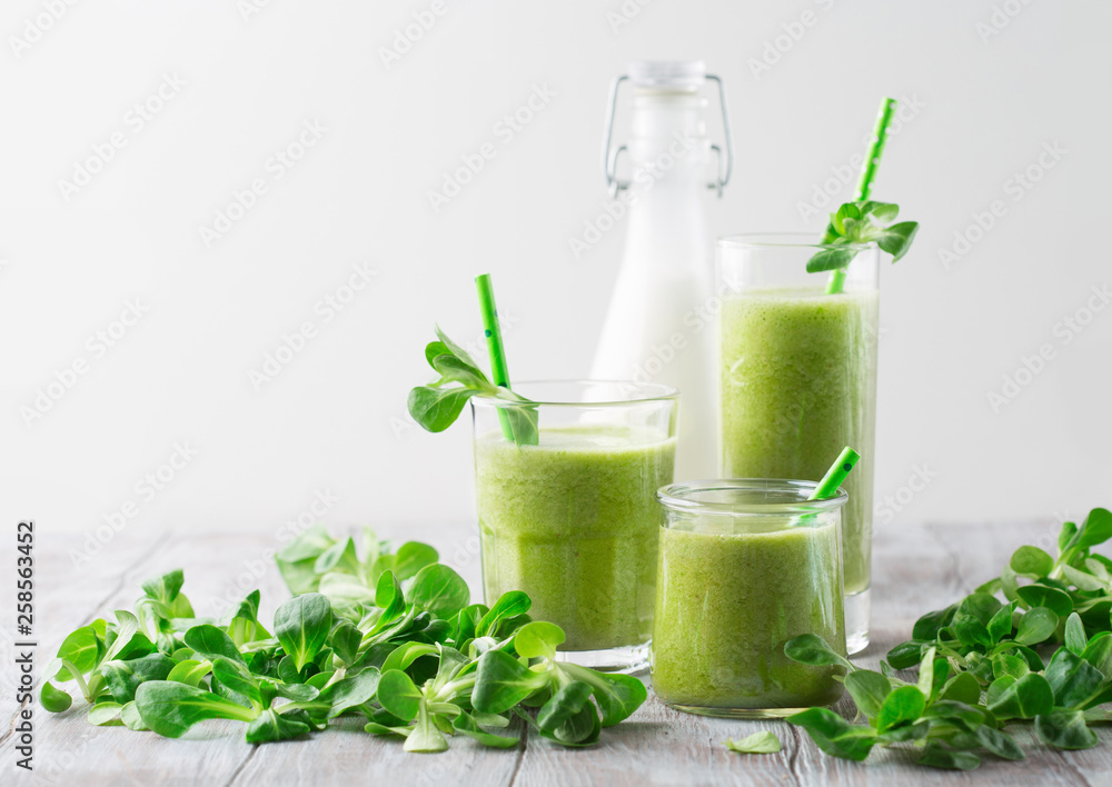 Detox diet concept: Green spinach smoothie on table Detox diet concept: Green spinach smoothie on table