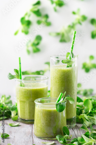 Detox diet concept: Green spinach smoothie on table