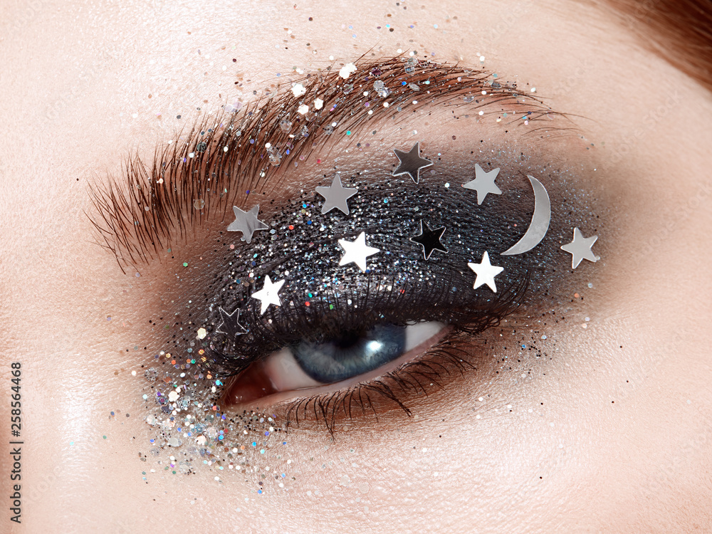 Eye makeup woman with decorative stars. Perfect makeup. Beauty fashion. False Eyelashes. Cosmetic Eyeshadow. Make-up Creative make-up the night sky with stars Photos Adobe Stock