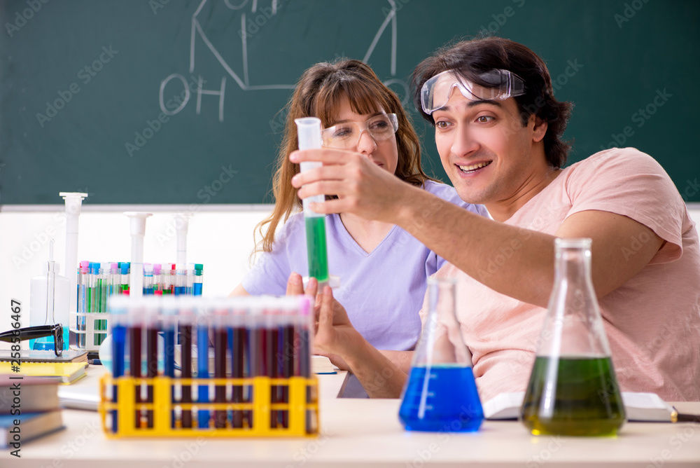 Two chemists students in classroom Two chemists students in classroom