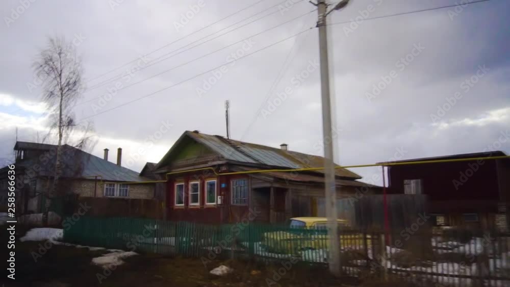 Driving moving through a village in Russia in winter. Old houses. Slow motion Driving moving through a village in Russia in winter. Old houses. Slow motion