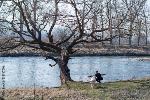 Dog and man by the river