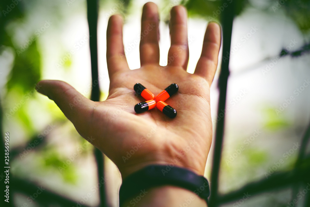 hand with medicine, in tne form of a cross hand with medicine, in tne form of a cross