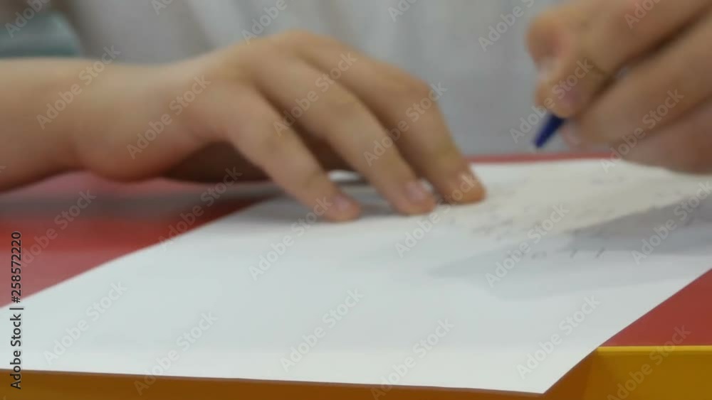 Boy teenager learns to write with his left hand Boy teenager learns to write with his left hand